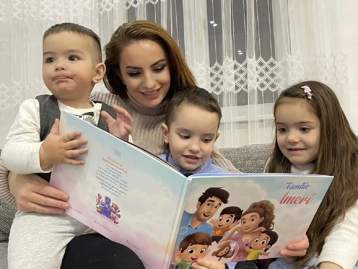 Eine Mutter mit ihren 3 Kindern sitzt auf der Couch und schaut sich das personalisierte Buch für Familien an. 